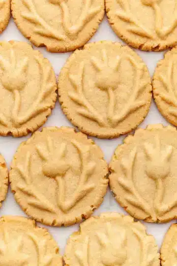 Brown sugar shortbread cookies with a stamped pattern on top.