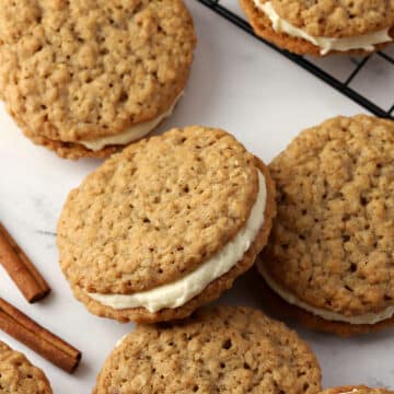 Chai oatmeal sandwich cookies spread on a counter.