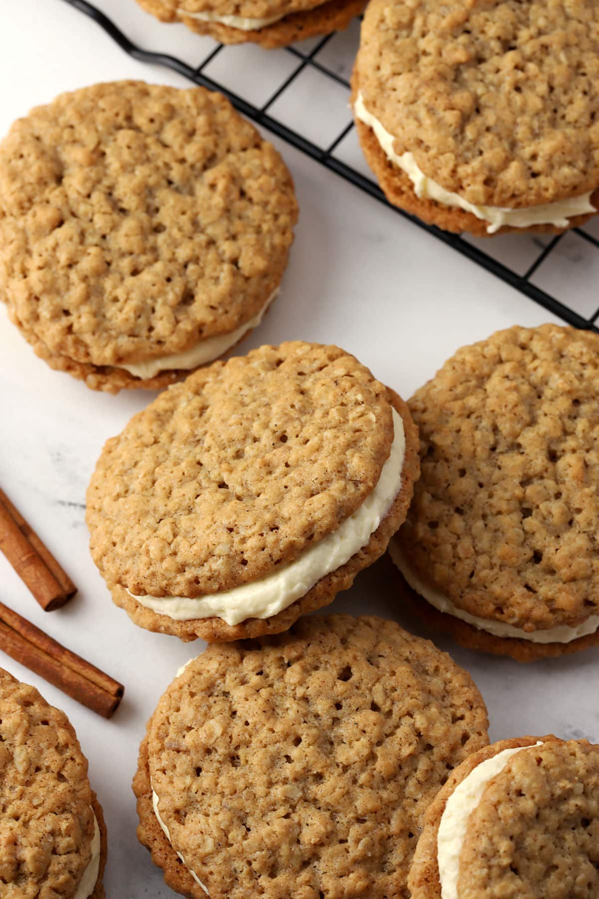 Chai oatmeal sandwich cookies spread on a counter.