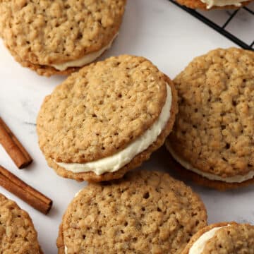 Chai oatmeal sandwich cookies spread on a counter.