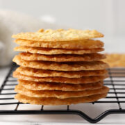 A stack of lace cookies on a cooling rack.