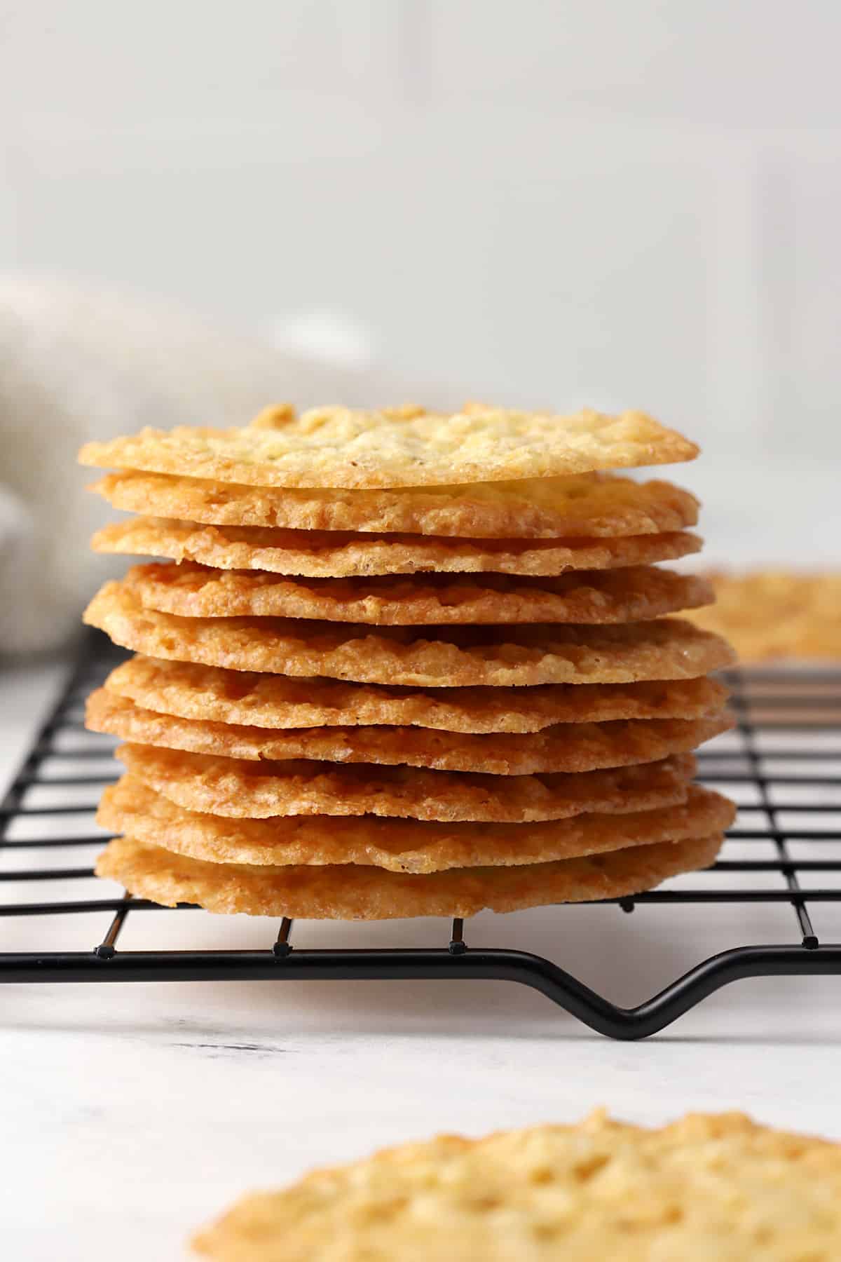A stack of lace cookies on a cooling rack.