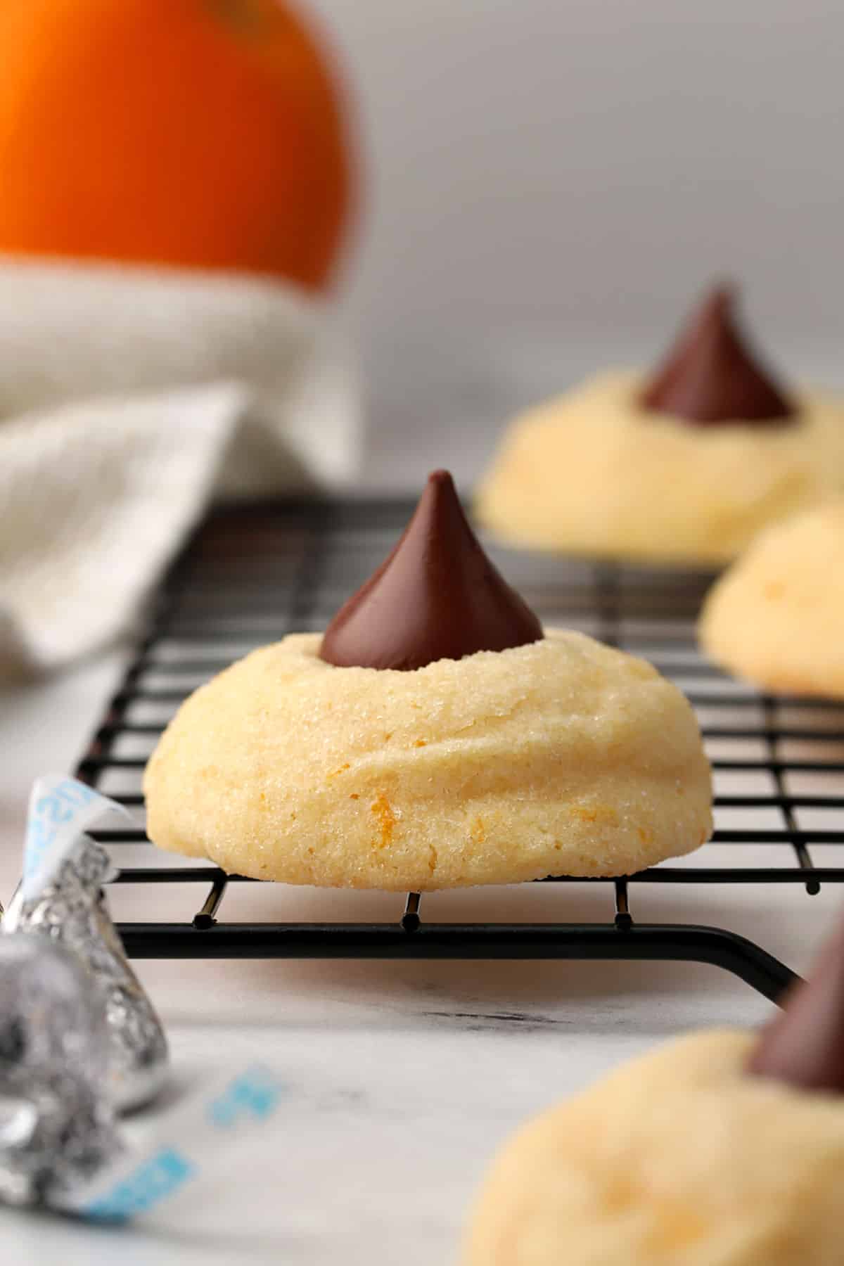 Orange blossom cookies on a cooling rack.