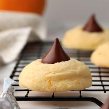 Orange blossom cookies on a cooling rack.