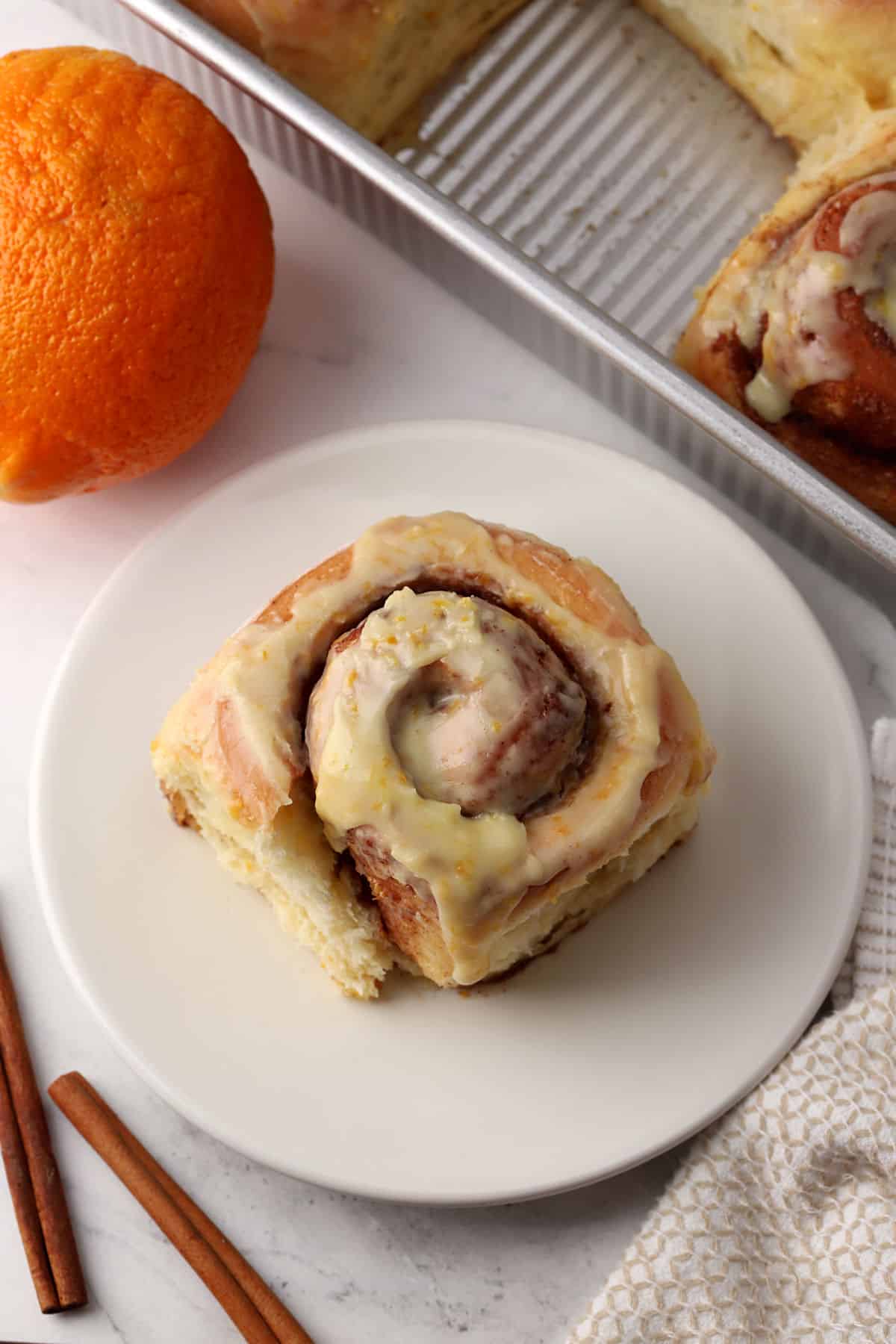 A cinnamon roll on a small plate.