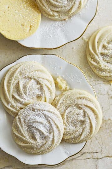 Sour cream butter cookies on a gold rimmed plate.