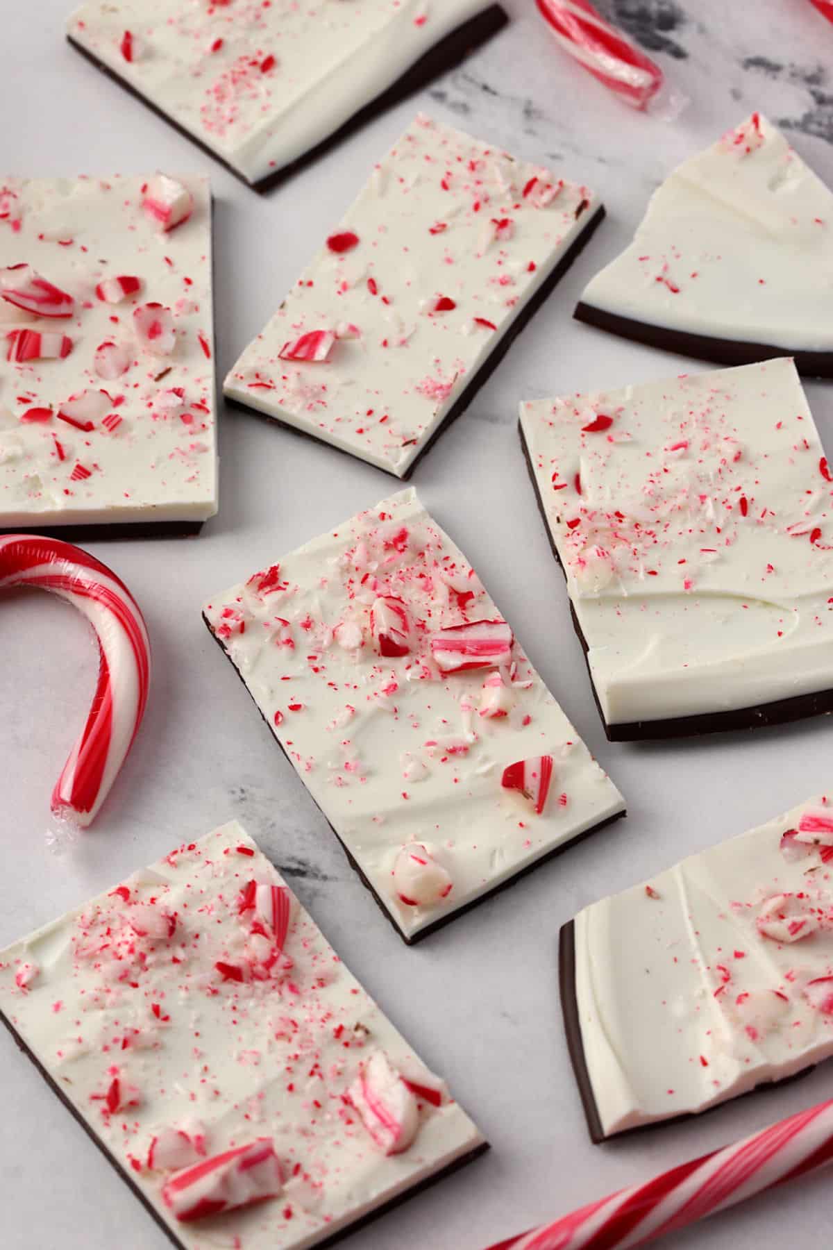 Squares of peppermint bark candy on a counter top.