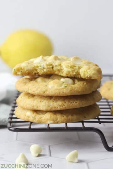 Stack of lemon zucchini cookies on a cooling rack.