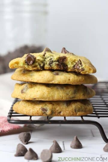 A stack of chocolate chip cookies on a cooling rack.
