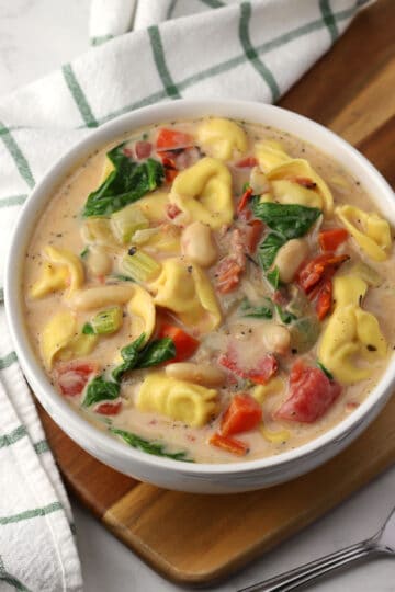 A bowl of tuscan tortellini soup.