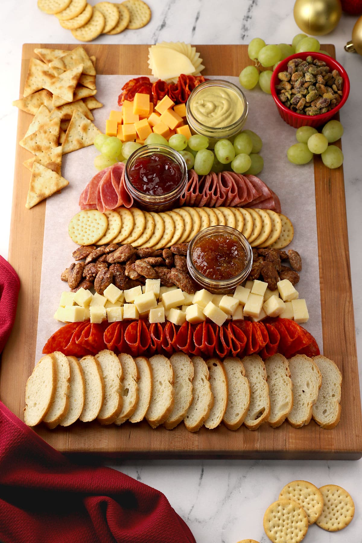 A charcuterie board shaped like a Christmas tree.