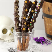 Glass filled with pretzel wands decorated with sprinkles.