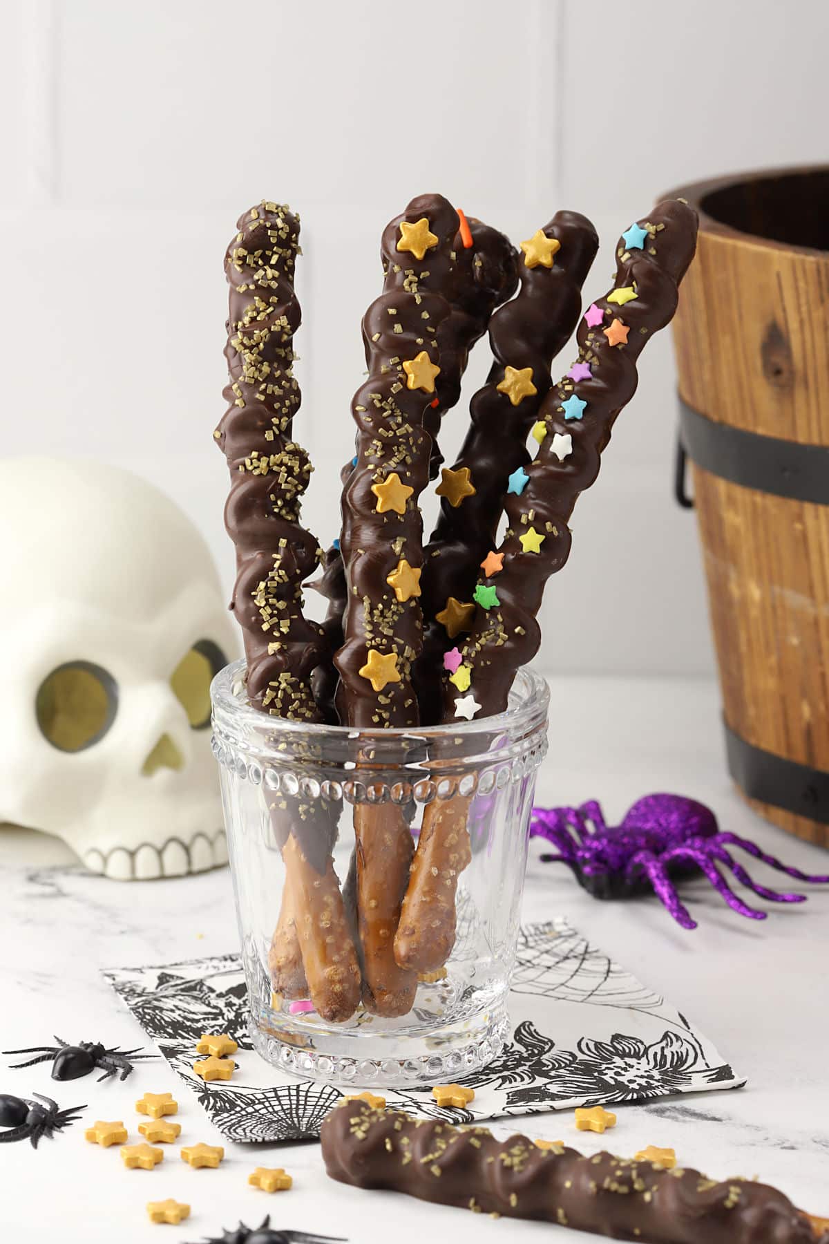 Glass filled with pretzel wands decorated with sprinkles.