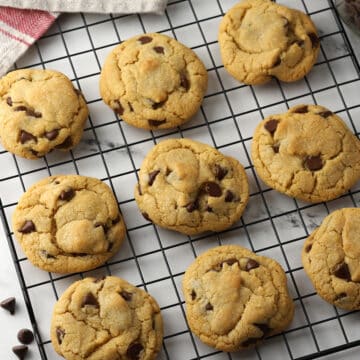 Chocolate chip cookies on a cooling rack.