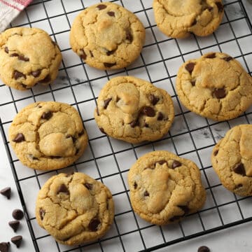 Chocolate chip cookies on a cooling rack.