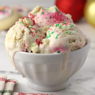 A bowl filled with Christmas cookie ice cream topped with sprinkles.