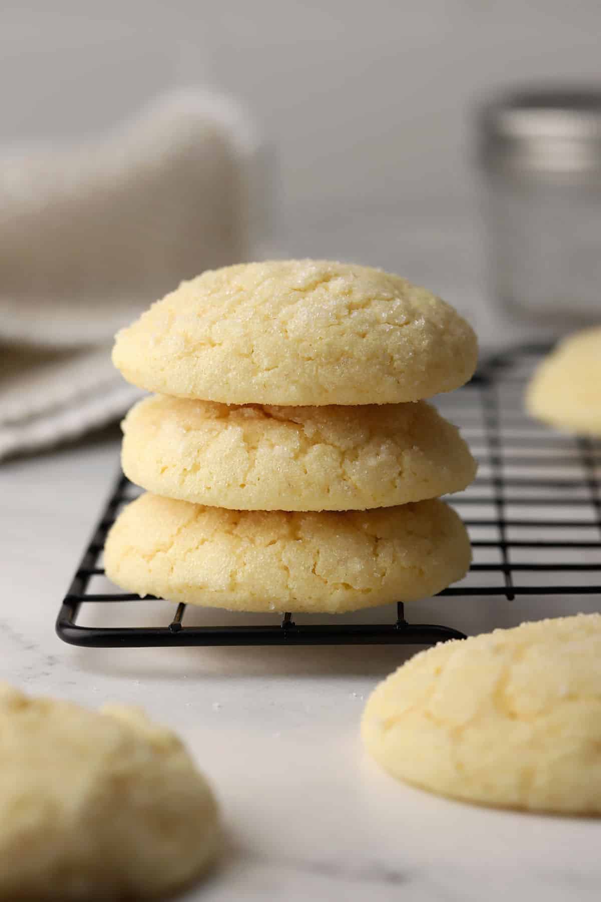 A stack of sugar cookies on a cooling rack.