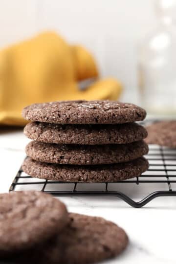 A stack of Dutch cocoa cookies on a cooling rack.