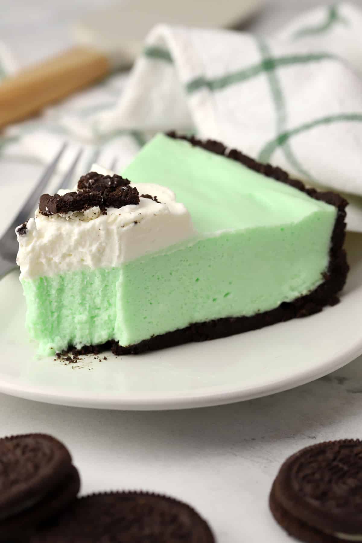A slice of grasshopper pie on a small plate.