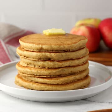 A stack of applesauce pancakes on a plate.