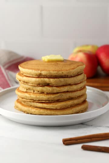 A stack of applesauce pancakes on a plate.