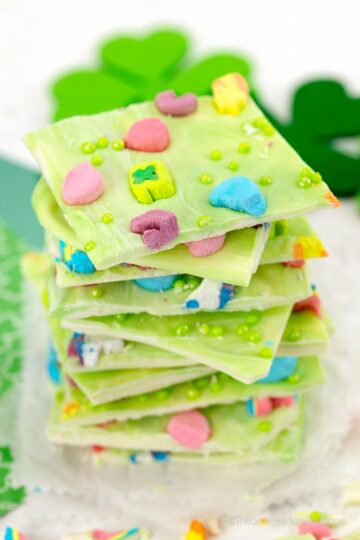 A stack of candy bark decorated with lucky charms.