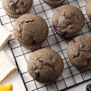 Buckwheat blueberry muffins on a cooling rack.