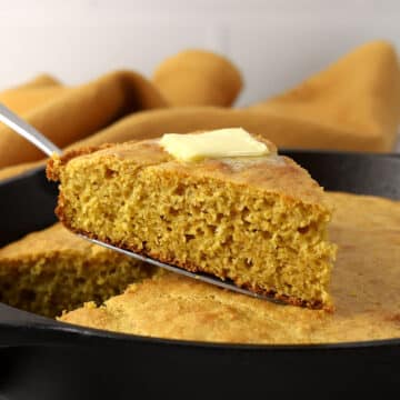 A slice of cornbread with butter melting on top.