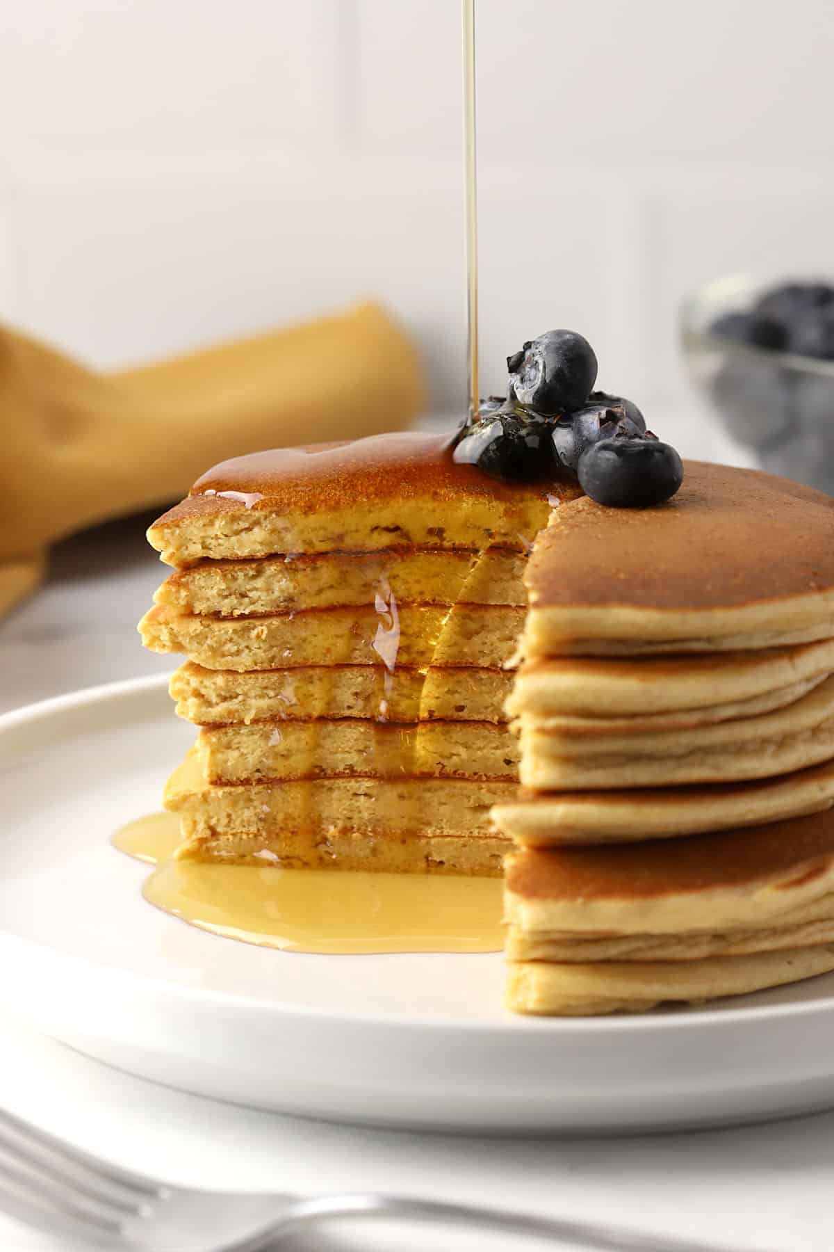 A stack of pancakes with a wedge missing.