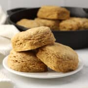 Three biscuits stacked on a plate.