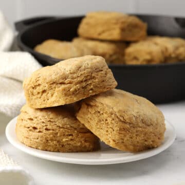 Three biscuits stacked on a plate.