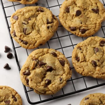 Chocolate chip cookies on a cooling rack.