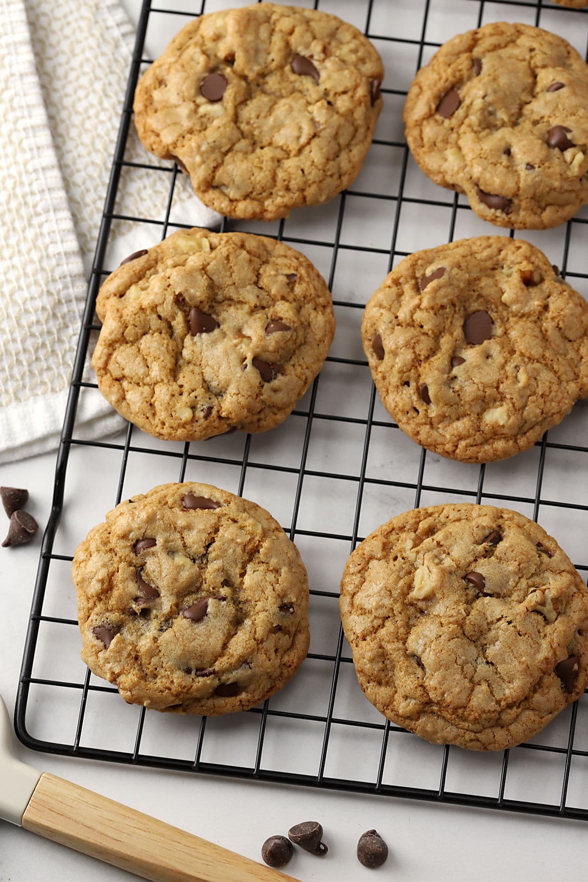 Chocolate chip cookies on a cooling rack.