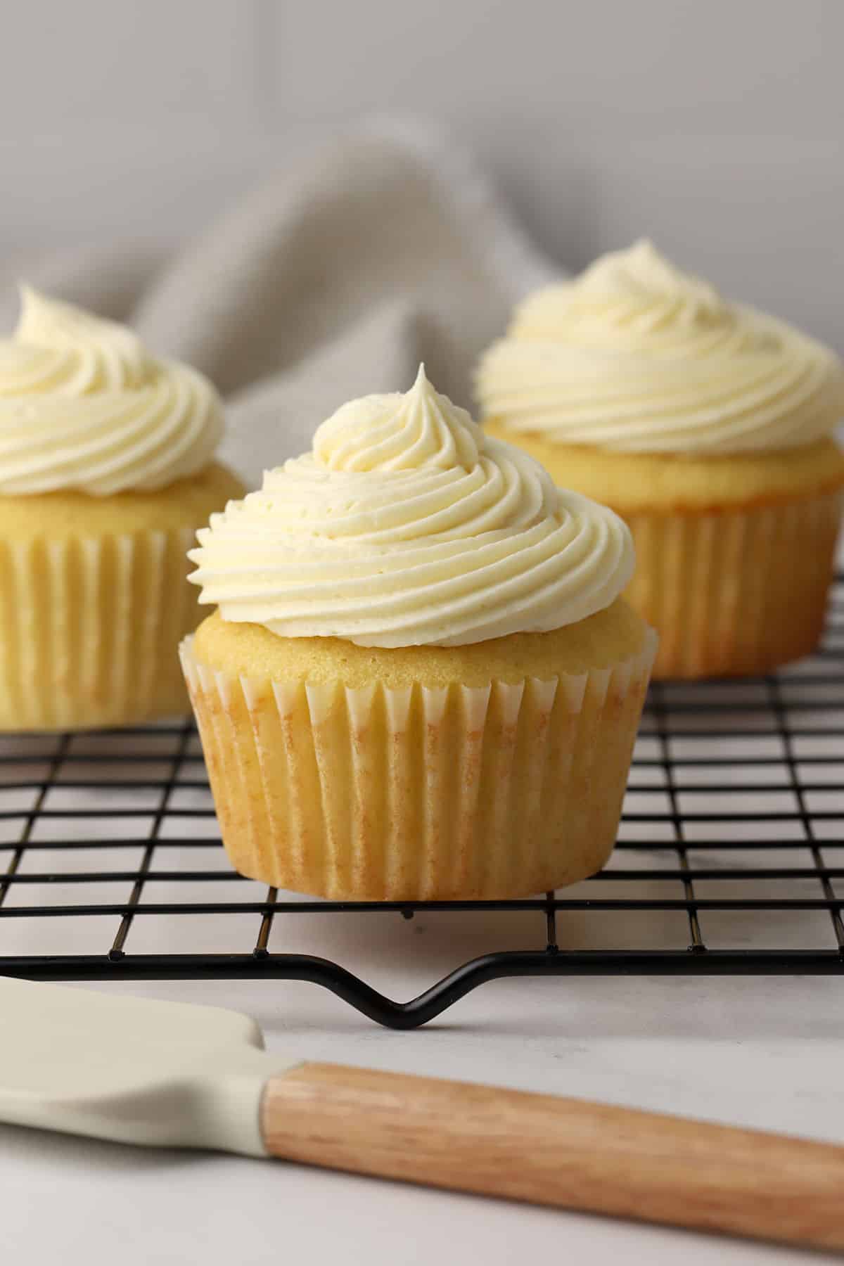 A buttermilk cupcake on a cooling rack.