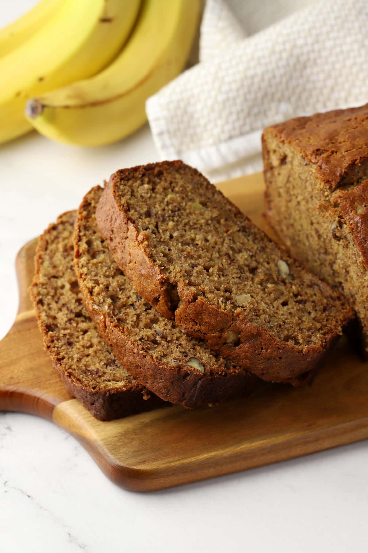 Slices of banana bread on a cutting board.