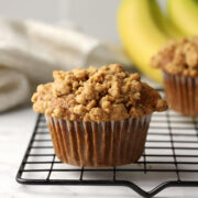 A spelt banana muffin on a cooling rack.