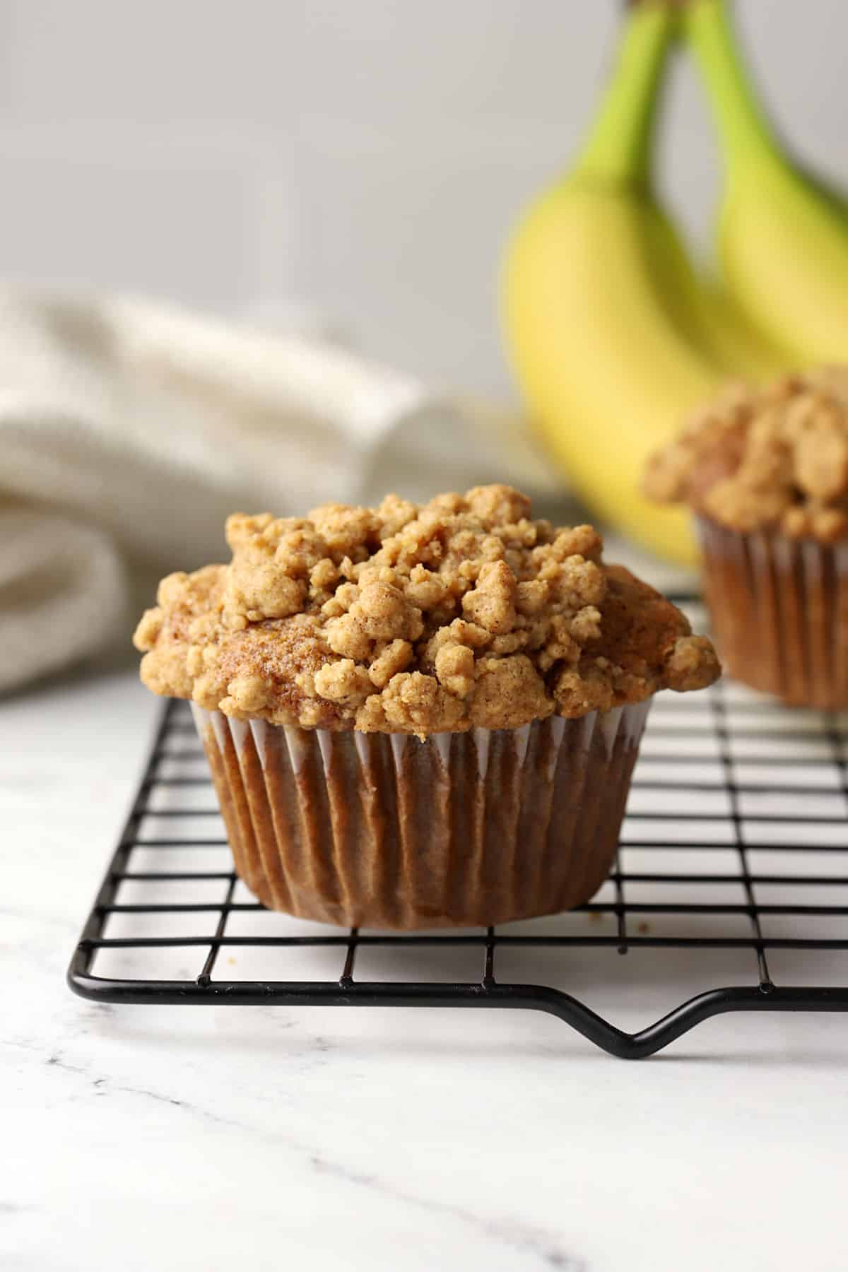 A spelt banana muffin on a cooling rack.
