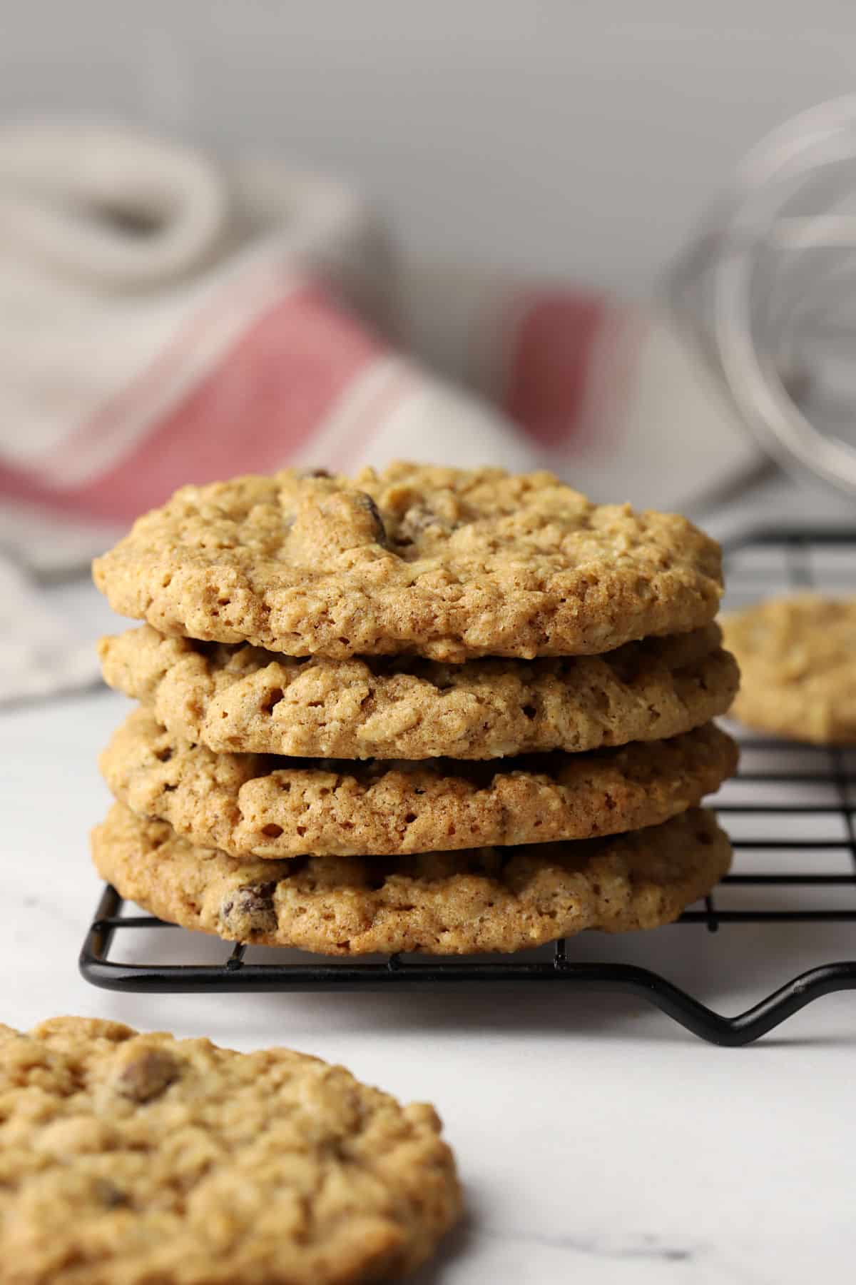 A stack of oatmeal raisin cookies on a cooling rack.