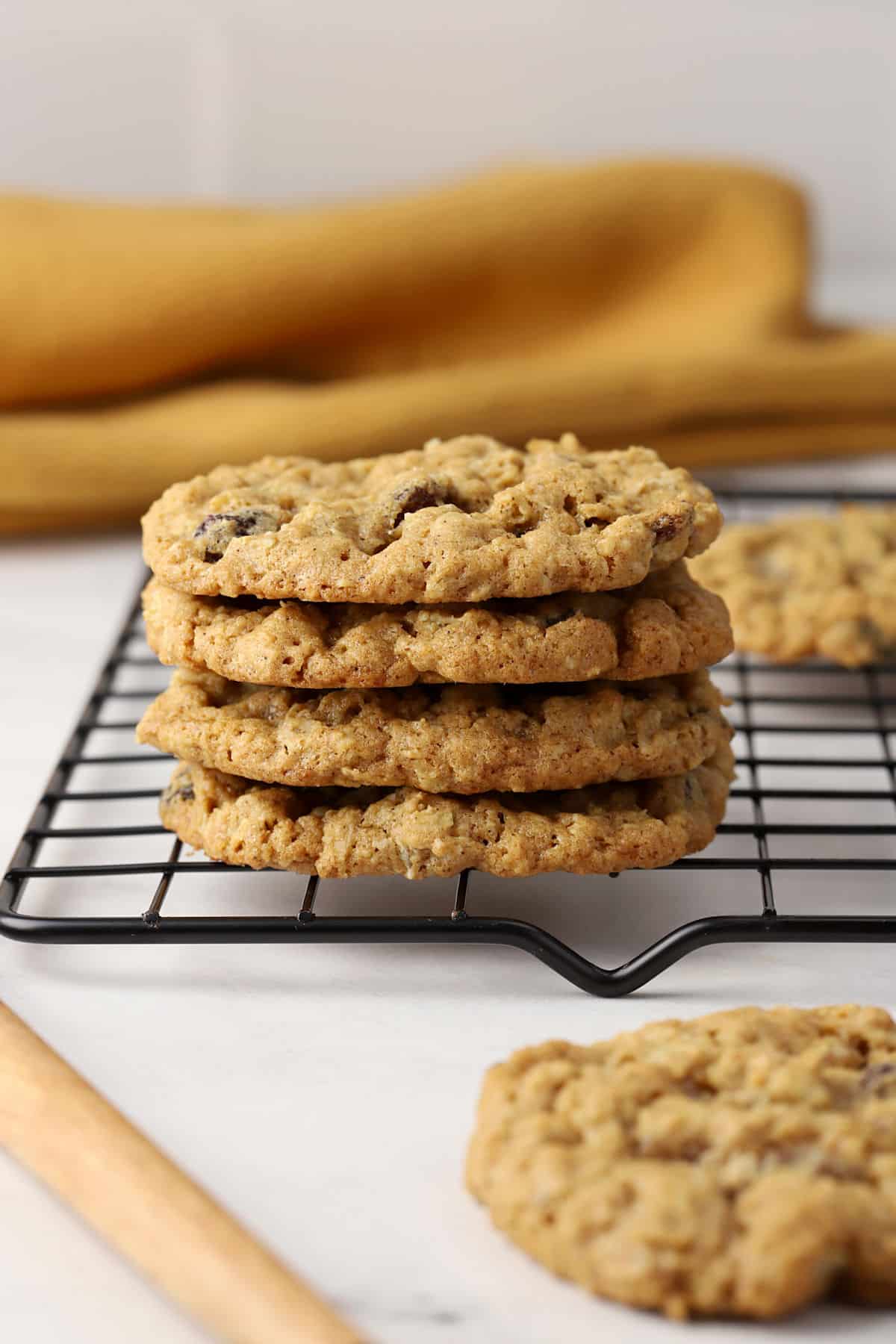 A stack of oatmeal cookies on a cooling rack.