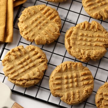 Peanut butter cookies on a cooling rack.