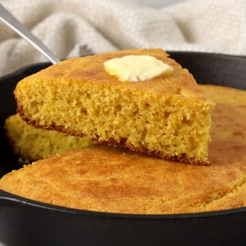 Slice of cornbread with butter on top.