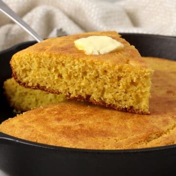Slice of cornbread with butter on top.