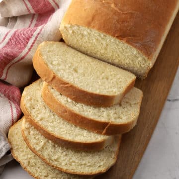 Slices of sandwich bread on a cutting board.