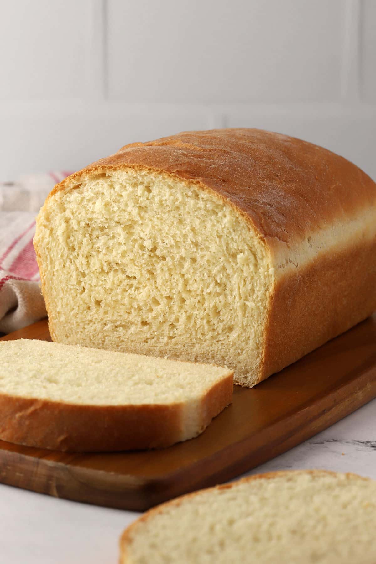A loaf of sandwich bread on a cutting board.
