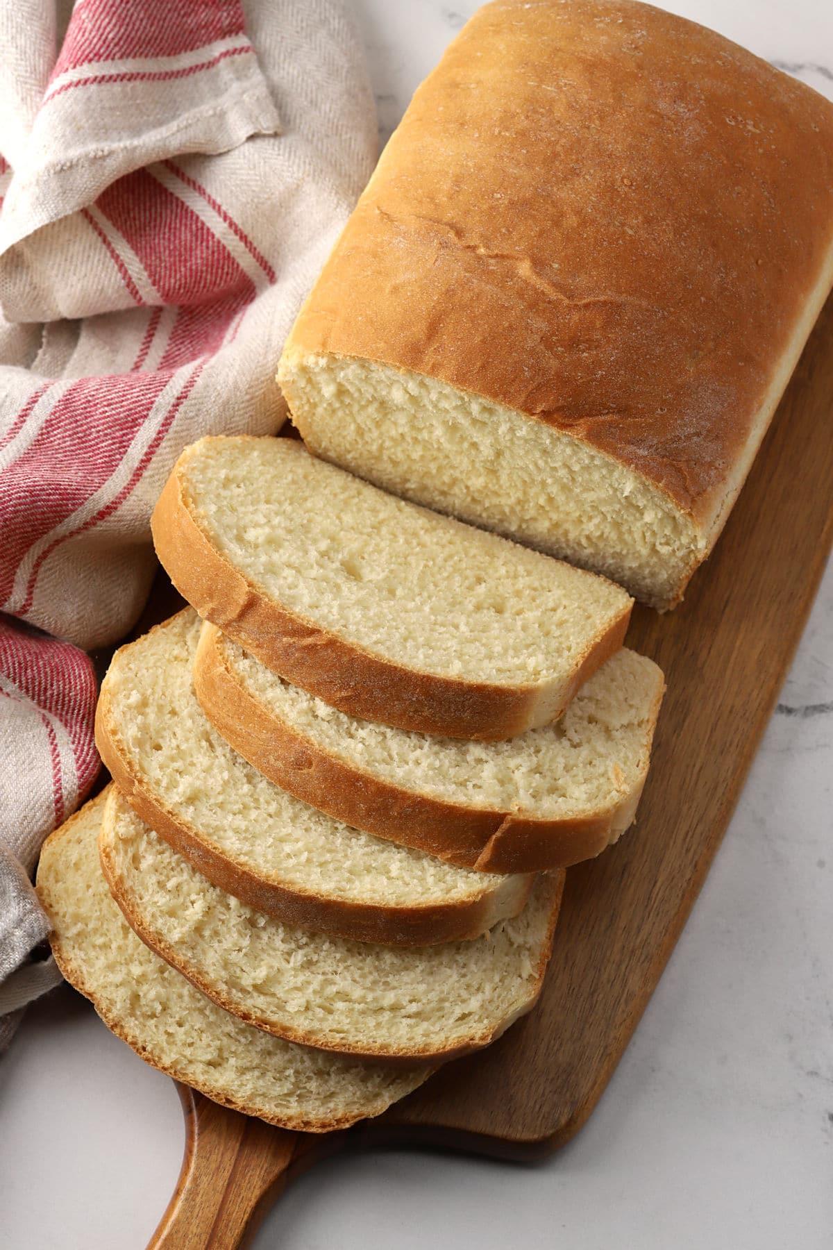 Slices of sandwich bread on a cutting board.