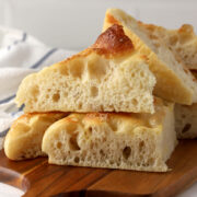 Wedges of focaccia on a cutting board.