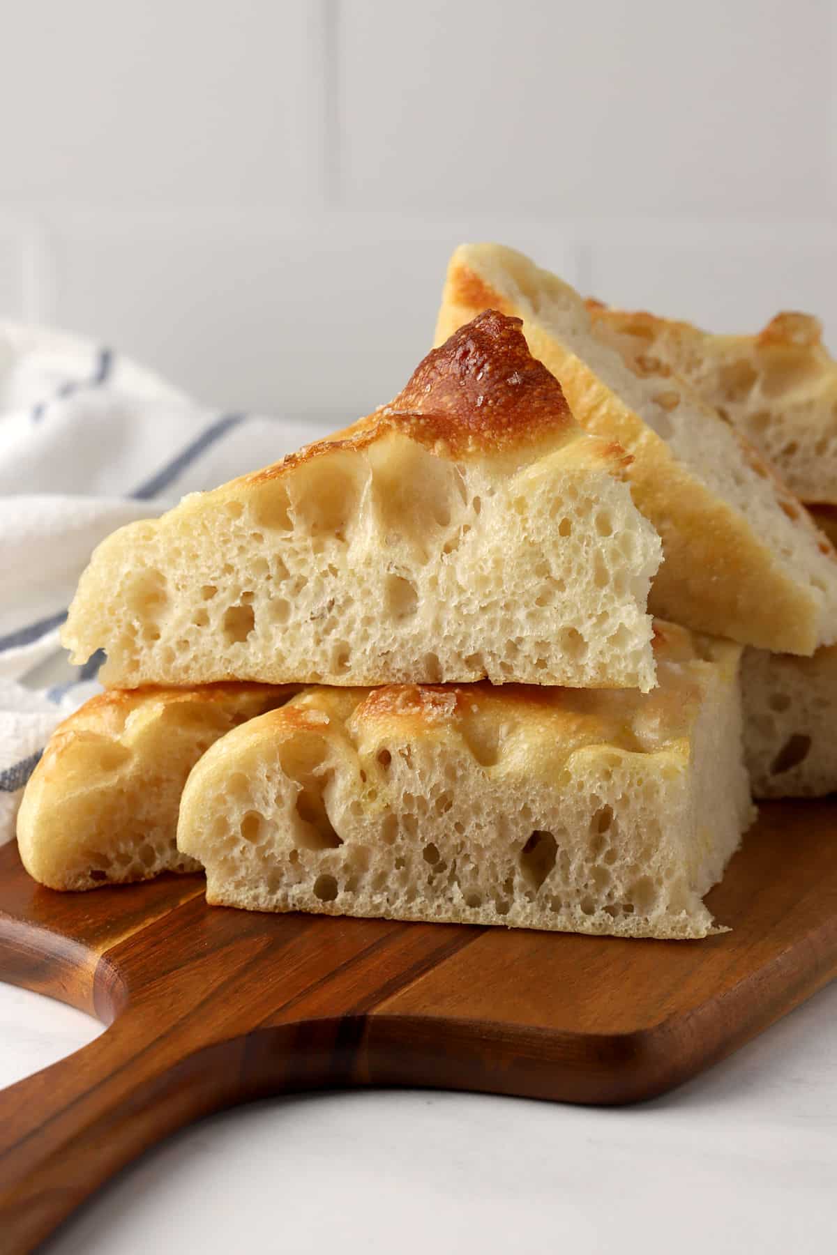 Wedges of focaccia on a cutting board.