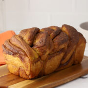 A loaf of pumpkin babka on a cutting board.