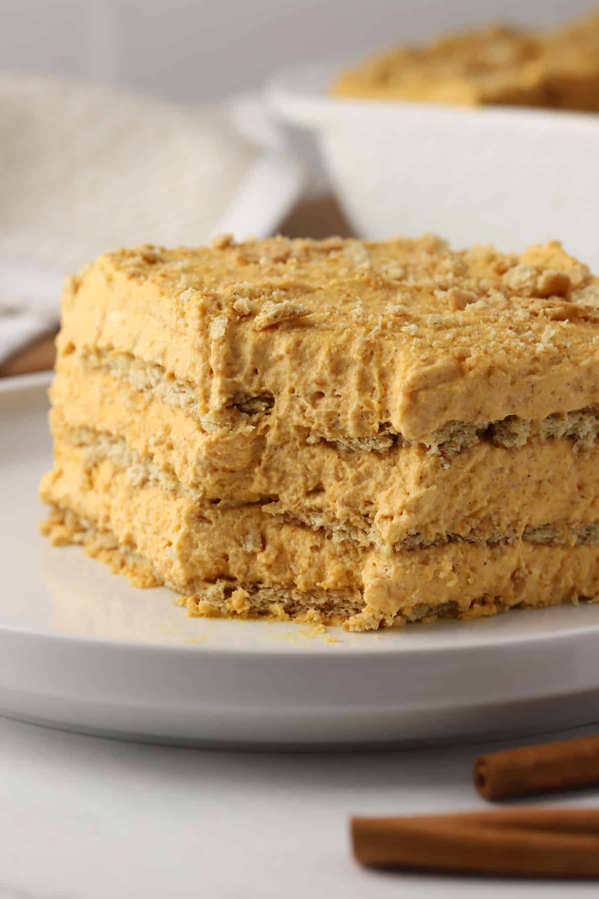 Slice of pumpkin icebox cake with a bite missing.